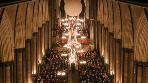 PA Candles are carried through Salisbury Cathedral during the advent procession