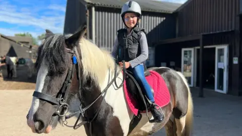 Family photo Imogen on a horse
