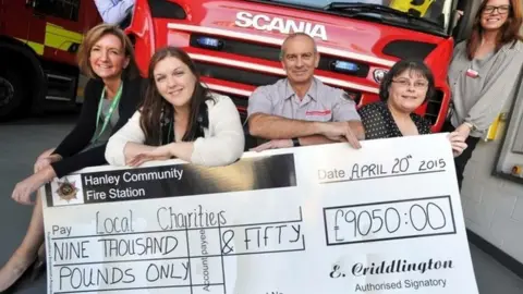 Staffordshire Fire and Rescue Service Kelvin with a cheque for a charity