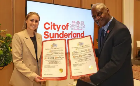 Raoul Dixon / NNP Stephanie Darby, nee Houghton, and Gary Bennett holding freedom of the city certificates