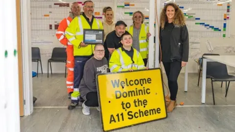 National Highways  Dominic and members of National Highways with a personalised traffic management sign