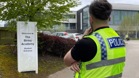 BBC / Simon Thake A police officer at the Birley Academy in Sheffield