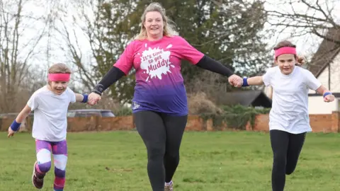 CRUK Emma and her two children, Naomi and Alan running