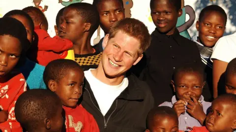 PA Prince Harry meets youngsters in the grounds of the Mants'ase children's home, while on a return visit to Lesotho in southern Africa
