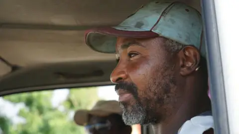 Gemma Handy Thomas Thomas sits in his truck