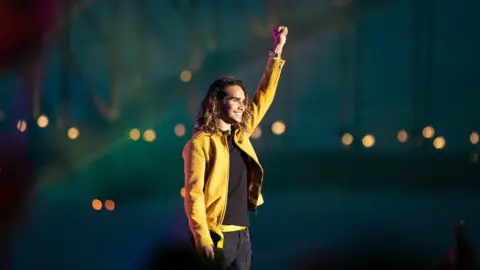 ABC News Isaiah Firebrace performs in front of Sydney Harbour Bridge