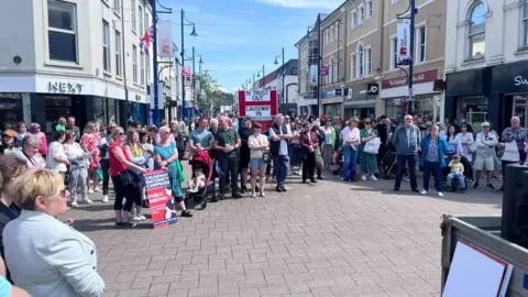 BBC About 100 people gathered in the town centre
