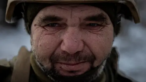 Reuters A Ukrainian serviceman of the 93rd separate mechanized brigade attends a Christmas Day service near the front line in the Donetsk region as Ukrainians celebrate their first Christmas according to a new calendar, amid Russia’s attack on Ukraine, December 25, 2023.