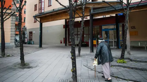 Getty Images A man walking outside his nursing home in Stockholm