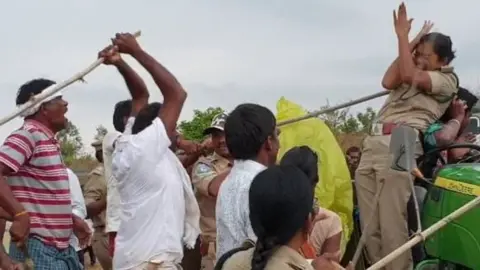 BBC Telugu A still from the viral video in which a mob of men are seen attacking a woman forest officer