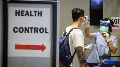 Getty Images A traveller being tested upon arrival at Suvarnabhumi Airport in Bangkok on 9 March