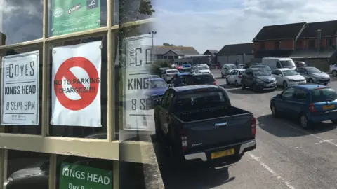 BBC Poster in shop window rejecting parking charges with car park in Llantwit Major