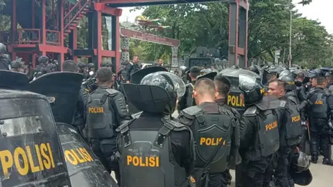 Getty Images Indonesian riot police take positions at a university in provincial capital Jayapura on September 23, 2019