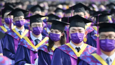 Getty Images Students attend 2021 Tsinghua University Degree Commencement Ceremony on June 27, 2021 in Beijing, China.