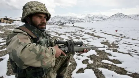 AFP A Pakistani soldier stands guard on the Pakistan-Afghan border