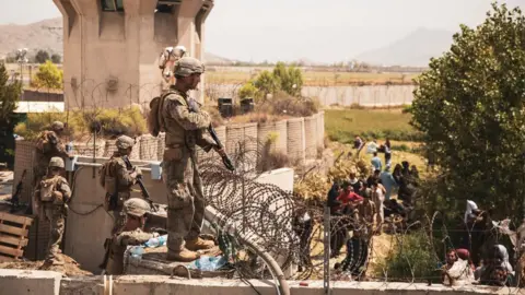 Reuters US troops stand guard at an Evacuee Control Checkpoint at Hamid Karzai International Airport, Kabul, Afghanistan, 20 August 2021