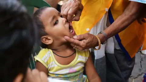 A child undergoing an immunisation course in India