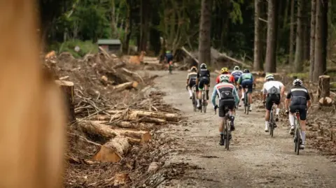 GRAN FONDO ISLE OF MAN The group of cyclists from behind riding away along the dirt track.