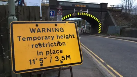 Network Rail The sign and damaged bridge