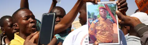 AFP Demonstrators gathering in Ouagadougou to show support to the military hold a picture of Paul-Henry Sandaogo Damiba the leader of Burkina Faso's coup - 25 January 2022