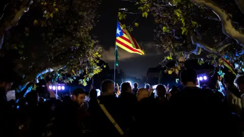 Reuters People attend a gathering in support of the members of the dismissed Catalan cabinet