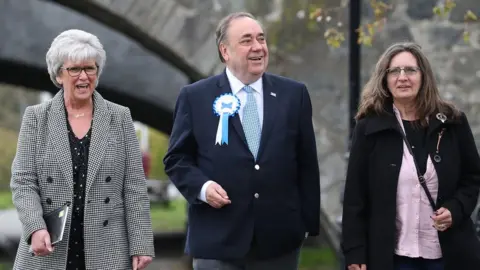 PA Alba party leader Alex Salmond in Ellon walking with two women
