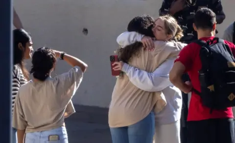 Getty Images Pepperdine University students embrace at vigil