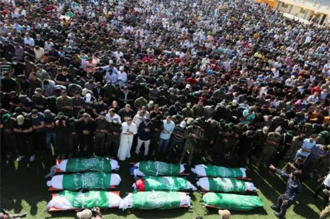 Reuters Thousands of people in Khan Younis attend a funeral for Palestinians killed during Israeli-Palestinian fighting, held on 21 May