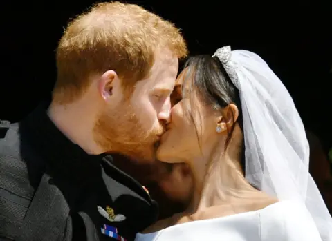 Reuters Prince Harry and Meghan Markle kiss on the steps of St George's Chapel in Windsor Castle