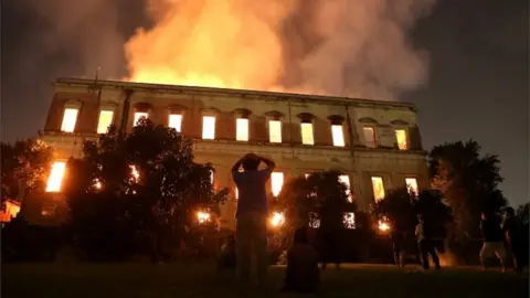 Reuters People watch as a fire burns at the National Museum of Brazil in Rio de Janeiro, .