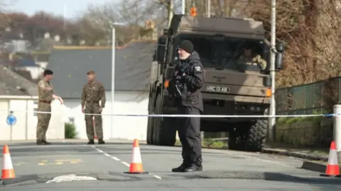 Matt Keeble/PA Wire Police and bomb disposal experts at the scene near St Michael Avenue, Plymouth