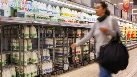 EPA Woman walking in a supermarket