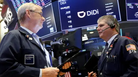 Reuters Traders work during the IPO for Chinese ride-hailing company Didi Global Inc on the New York Stock Exchange.