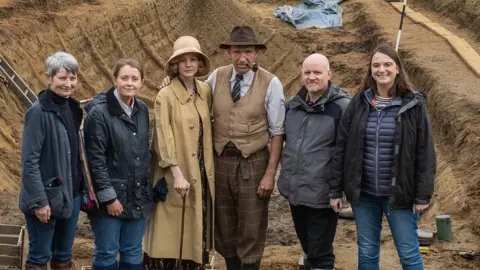 Larry Horricks/Netflix National Trust team with actors Carey Mulligan and Ralph Fiennes (centre)