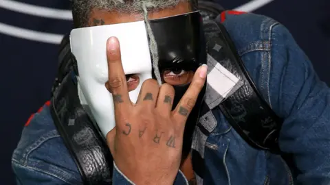 Getty Images XXXTentacion wearing a half black, half white mask