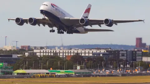 Getty Images Plane takes off over scorched grass at Heathrow Airport