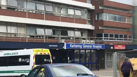 Stuart Ratcliffe/BBC Hospital front entrance with ambulance parked outside