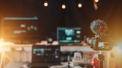 Getty Images A camera and monitors in a studio gallery