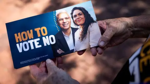 Getty Images A 'How to vote No' pamphlet is being held by a No campaign volunteer on October 07, 2023 in Perth, Australia. A referendum for Australians to decide on an indigenous voice to parliament will be held on October 14, 2023