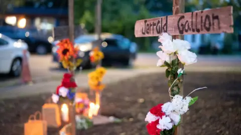 Getty Images Candles burn at the memorial for Jerrald Gallion