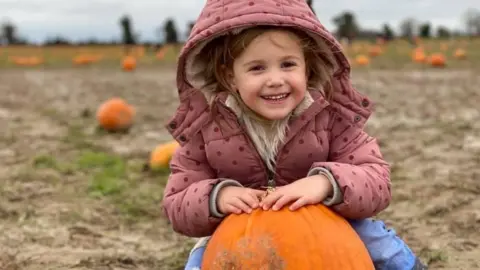 Simone Glennen/Lyla's family Lyla Blue Glennen smiling with a pumpkin