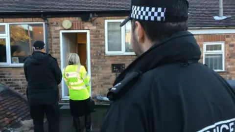 Police and Environment Agency waiting outside flat in Sneinton that was raided