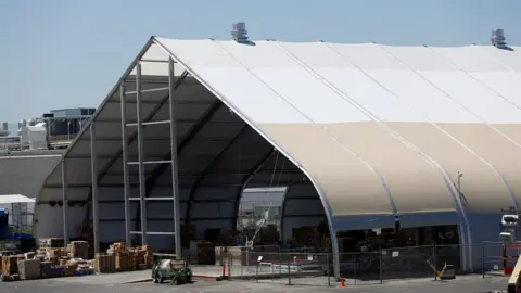 Reuters Tesla set up an additional assembly line in a tent to reach its Model 3 target