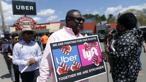 Getty Images Protestor in front of Uber sign