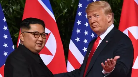 AFP/Getty Images North Korea's leader Kim Jong-un (left) and US President Donald Trump in Singapore. Photo: 12 June 2018