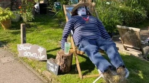 Jayne Garland Scarecrow sitting in a deckchair