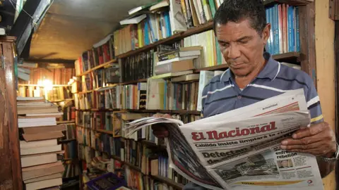 A man reads a newspaper in a bookshop in Santo Domingo