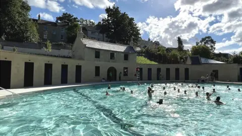 Kitty Dimbledy Cleveland Pools lido with people swimming in it on a sunny day