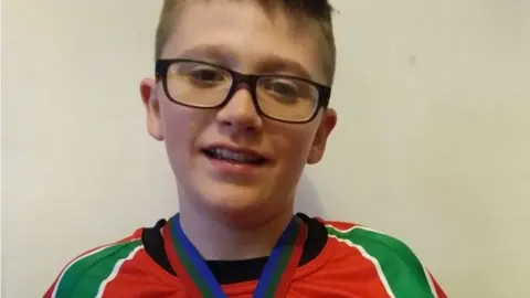 family photo A young Kai wearing a medal