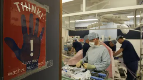 Getty Images Think Have You Washed Your Hands poster with medics working in background